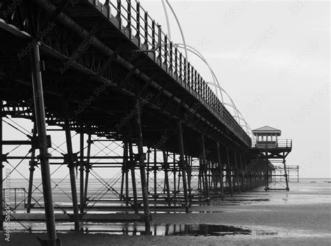 southport pier showing beach and structure in the evening monochrome ...