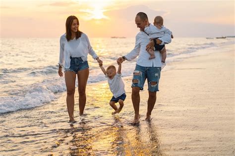 Premium Photo | Happy family having fun playing beach in summer vacation on the beach Happy ...