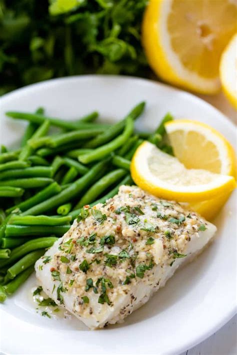 Easy Baked Cod Fish is smothered in a lemon garlic parmesan mixture that makes for a delicious ...