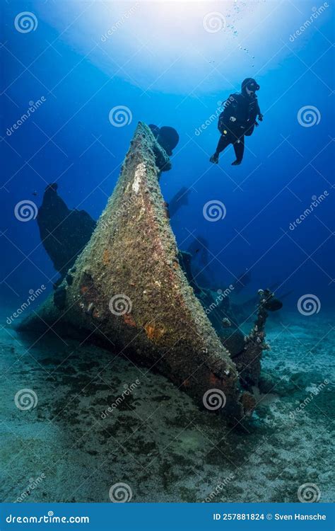 A Scuba Diver Explores a Sunken Shipwreck at the Seabed of the Aegean ...