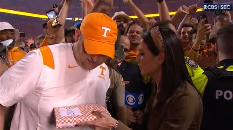 CBS reporter Jenny Dell gives Josh Heupel cigars after upset win