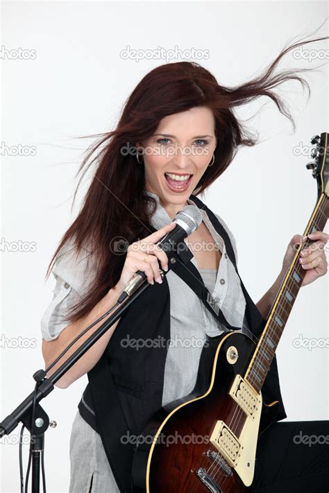 Girl playing guitar and singing — Stock Photo © photography33 #16017467