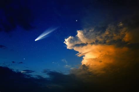 A bright comet flies over the Earth, which can be seen once every ...