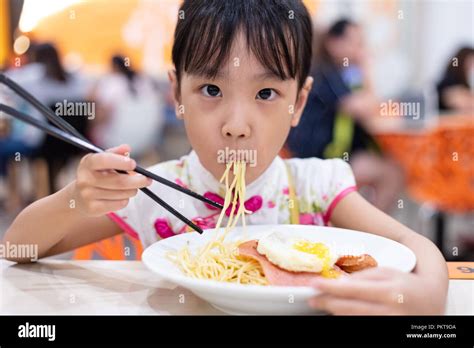 Girl eating spaghetti chopsticks hi-res stock photography and images ...