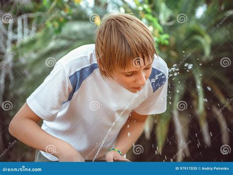 Boy Drinking Water from a Fountain Stock Photo - Image of public, cool: 97917030