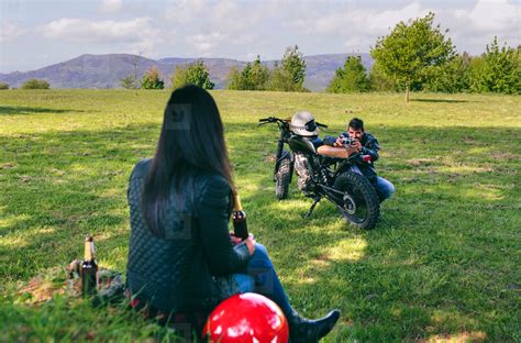 Couple resting from a motorcycle trip taking picture stock photo ...