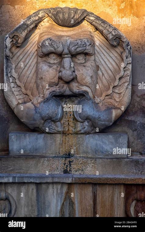 Wall mounted water fountain on the Aventine Hill in Rome Stock Photo - Alamy