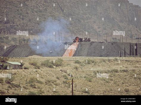 1970s America: Slag pours from Phelps Dodge Corporation copper mine. In background is the ...