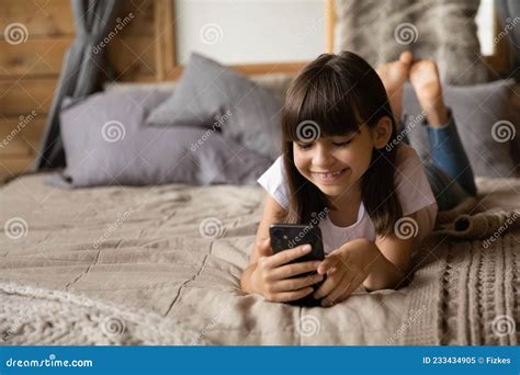 Smiling Pretty Kid Using Smartphone at Home, Relaxing on Bed Stock Image - Image of happy, look ...