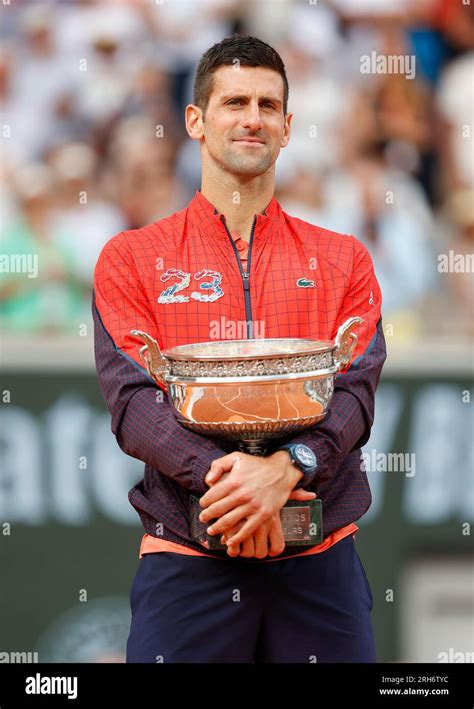 Serbian tennis player Novak Djokovic holding the championship trophy is ...