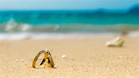 Honeymoon on tropical island, two wedding rings on the beach - Aviva ...