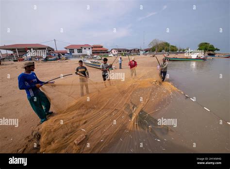 Kuala Muda, Penang/Malaysia - Mar 19 2017: Fisherman clean fishing net near beach Stock Photo ...