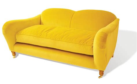 a yellow couch sitting on top of a white floor