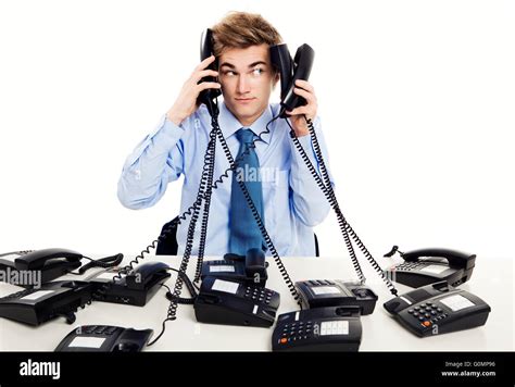 Young man in the office and answering several phones at the same time Stock Photo - Alamy