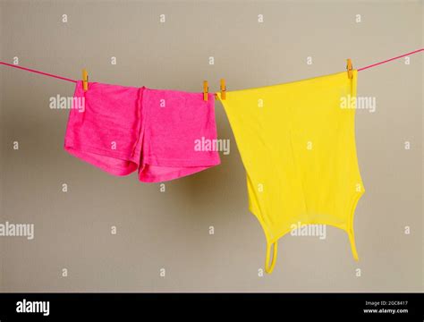 Laundry line with clothes on wall background Stock Photo - Alamy