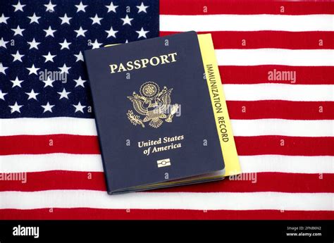 US Passport book with Immunization record card on the Flag of the United States - San Jose ...