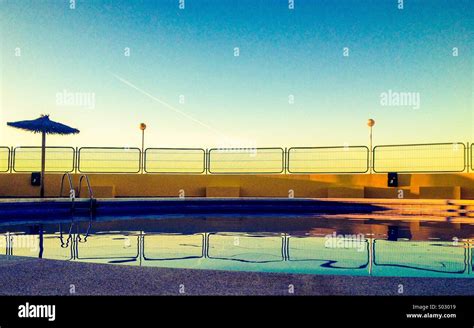 Swimming pool at sunrise Stock Photo - Alamy