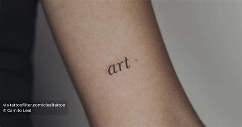 Word "art" tattooed on the inner forearm.