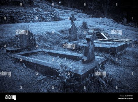 Spooky Halloween graveyard in fog in moonlight Stock Photo - Alamy