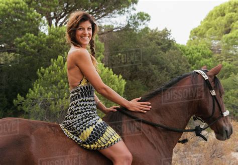 A woman riding horseback; Tarifa, Cadiz, Andalusia, Spain - Stock Photo - Dissolve