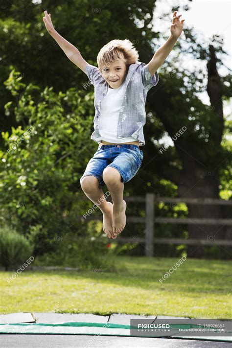 Boy jumping on trampoline — Oxfordshire, fun - Stock Photo | #158926664