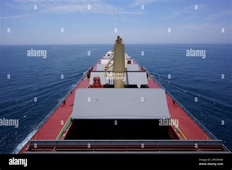 Bulk carrier proceeding loading port with open holds Stock Photo - Alamy