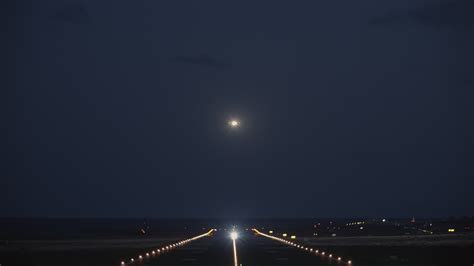 A night view of a runway with a taking off plane 29937458 Stock Video ...