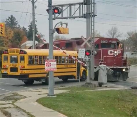 VIDEO: Crossing arm comes down on school bus in terrifying close call ...