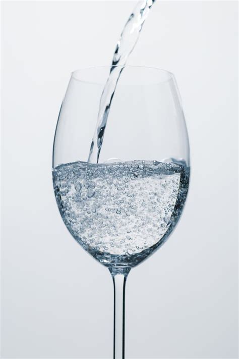 Pour Mineral Water into Wine Glass Stock Photo - Image of motion, bubble: 110743518