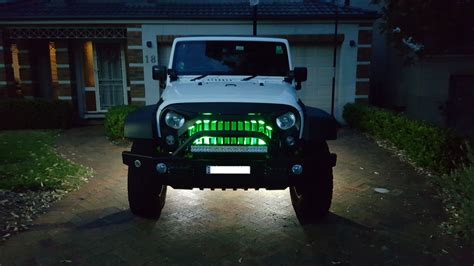 Jeep Wrangler JK - Lux LED Rock lights. 4 underneath and 2 green behind grille. Grille is a ...