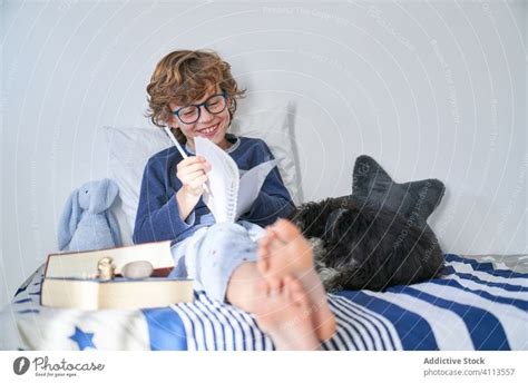 blond boy with glasses writing in a notebook - a Royalty Free Stock Photo from Photocase