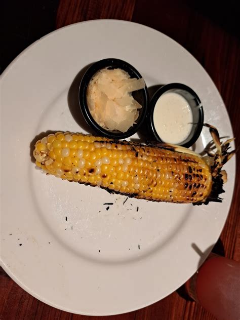 Roasted corn with crema and cheese on the side - Photo from LongHorn ...