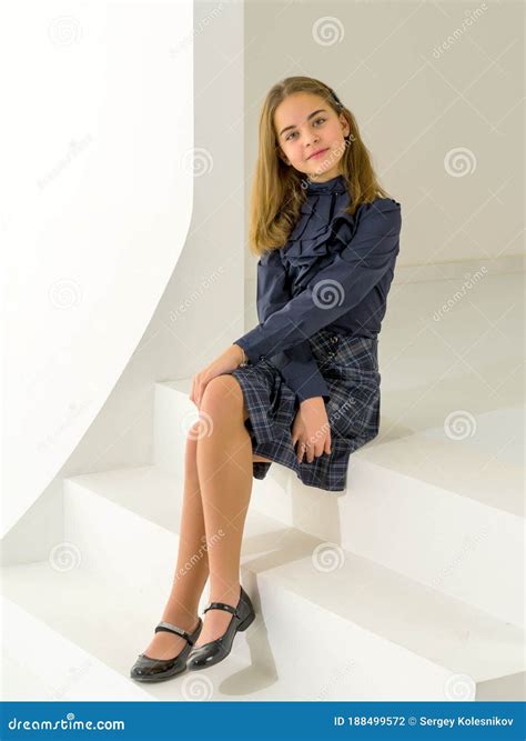 Cute Little Girl is Sitting in the Studio on the White Stairs. Style and Fashion Concept, Happy ...