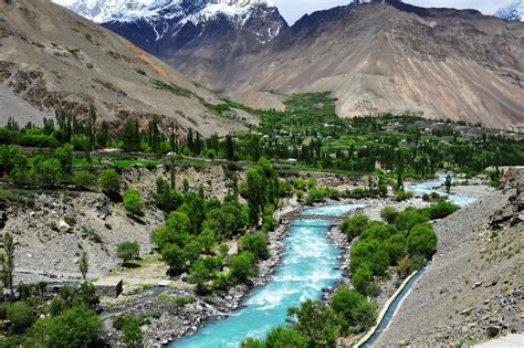 The turquoise blue river Gilgit flowing through the Chitral Valley in ...