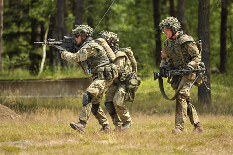 Soldiers of the Royal Danish Army run to an objective at Grafenwöhr ...