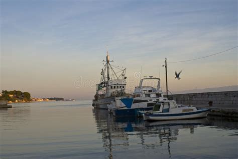 Fishing boats at sunset stock image. Image of sailing - 156719347