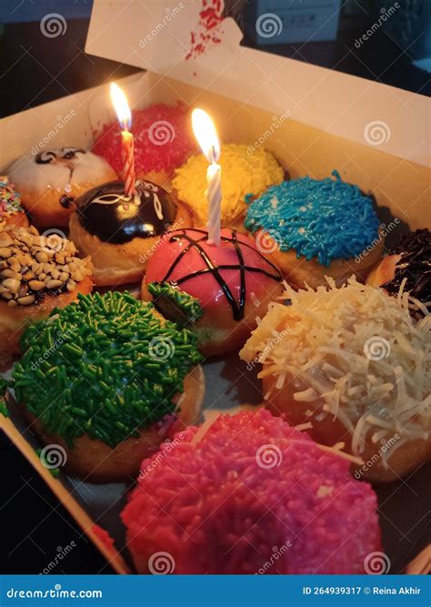 Rainbow Donut and candle stock image. Image of snack - 264939317