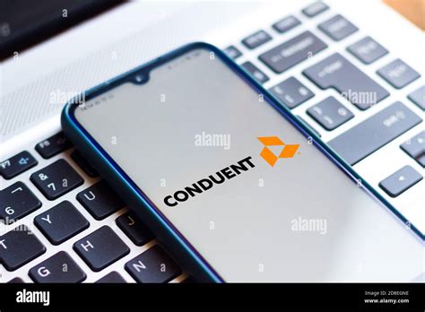 In this photo illustration the Conduent logo seen displayed on a smartphone Stock Photo - Alamy