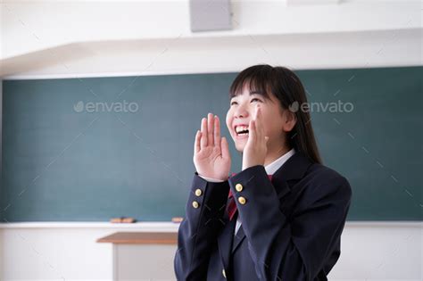 A Japanese junior high school girl cheers in her classroom Stock Photo by cait00sith