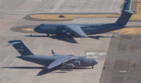 Air Force C-5 Galaxy and a C-17 Globemaster sit on the tarmac at ...