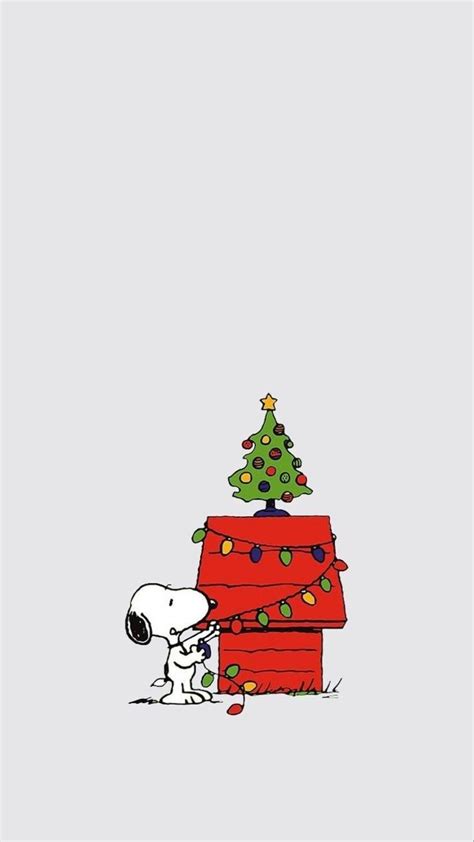 snoopy and his christmas tree on top of a house