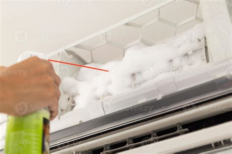 air conditioner cleaning with spray foam cleaner 13002047 Stock Photo at Vecteezy