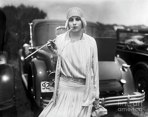 Woman Holding Long Cigarette Holder by Bettmann