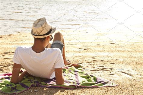 Young man lying on the beach stock photo containing beach and vacation ...