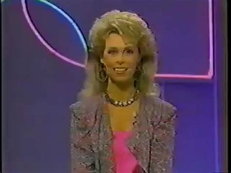 a woman in a pink dress and jacket on the television show's tv set