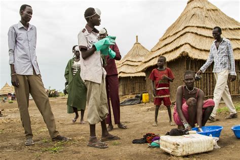 Volunteer sanitation workers inform refugees on use of pit… | Flickr