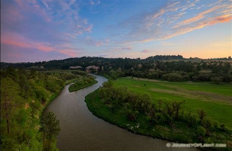 The Niobrara river west of Niobrara National Wildlife Refuge, snakes through a lush green valley ...