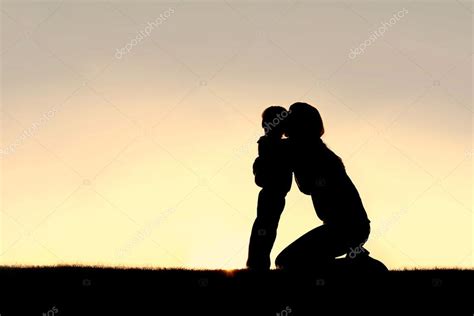 Silhouette of Young Mother Hugging Toddler Son at Sunset Stock Photo by ©Christin_Lola 69572527