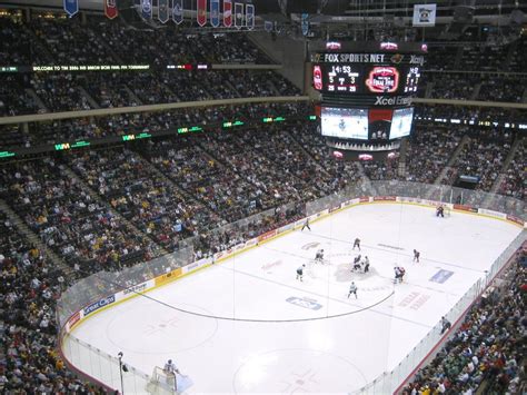 an overhead view of a hockey stadium with fans and players on the ice during a game