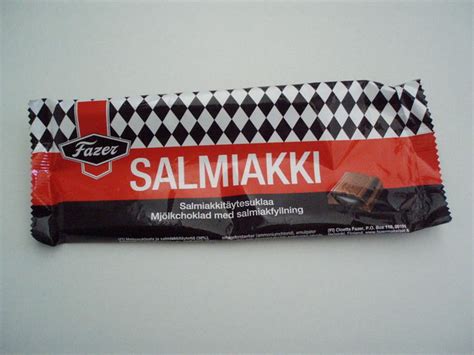 Foreigners eating salty black Finnish liquorice Salmiakki in Finland